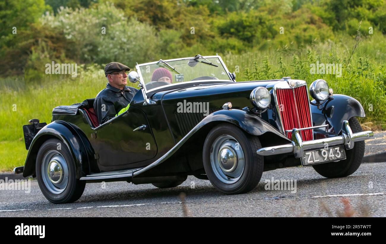 Stony Stratford,UK - June 4th 2023:  1950 black MG sports car classic car travelling on an English country road. Stock Photo