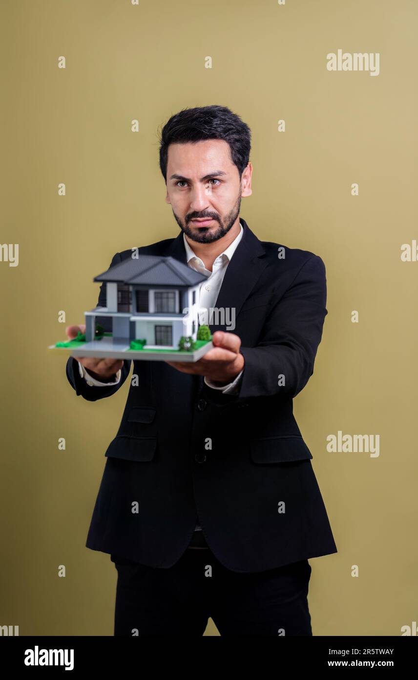 Real estate agent hold house model sample on isolated background