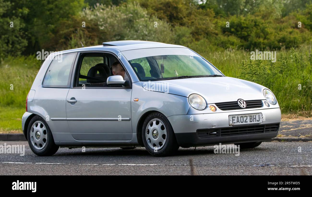Stony Stratford,UK - June 4th 2023: 2002 silver VOLKSWAGEN LUPO classic car travelling on an English country road. Stock Photo