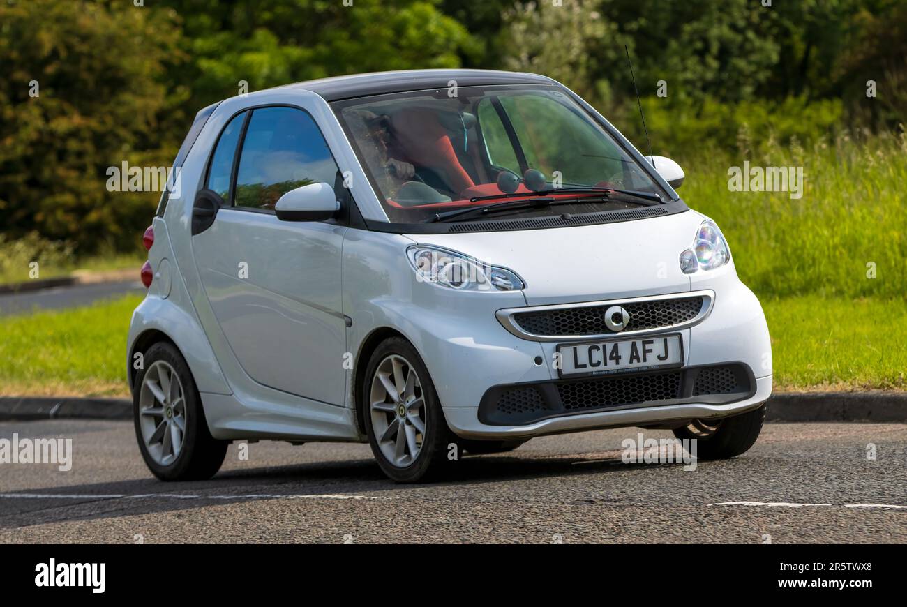 Stony Stratford,UK - June 4th 2023: 2014 white SMART (MCC) FORTWO     classic car travelling on an English country road. Stock Photo