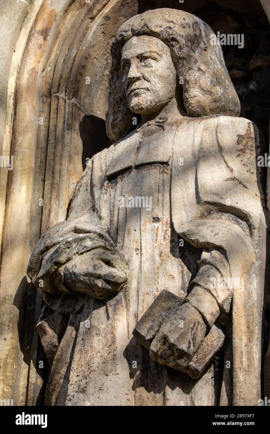 Essex, UK - March 24th 2023: A sculpture of Thomas Plume - English churchman and philanthropist, on the exterior of the historic All Saints Church in Stock Photo