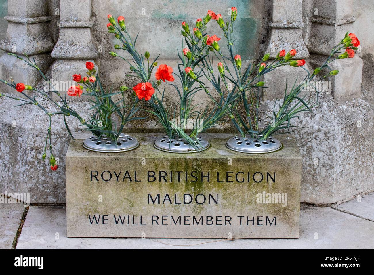 Essex, UK - March 24th 2023: Close-up of flowers at the base of the War Memorial in the town of Maldon in Essex, UK. Stock Photo