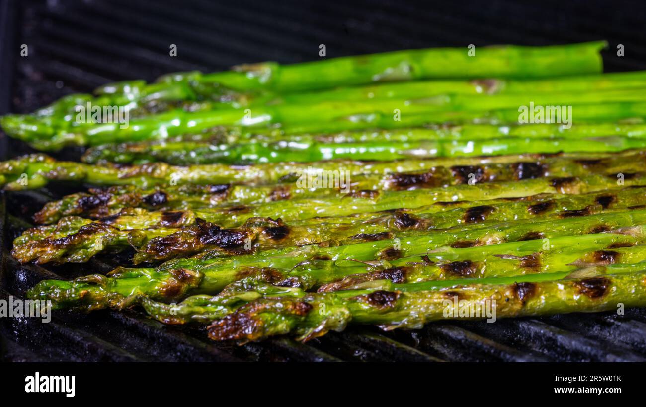 Fresh asparagus on cast iron grill. Close up. Stock Photo