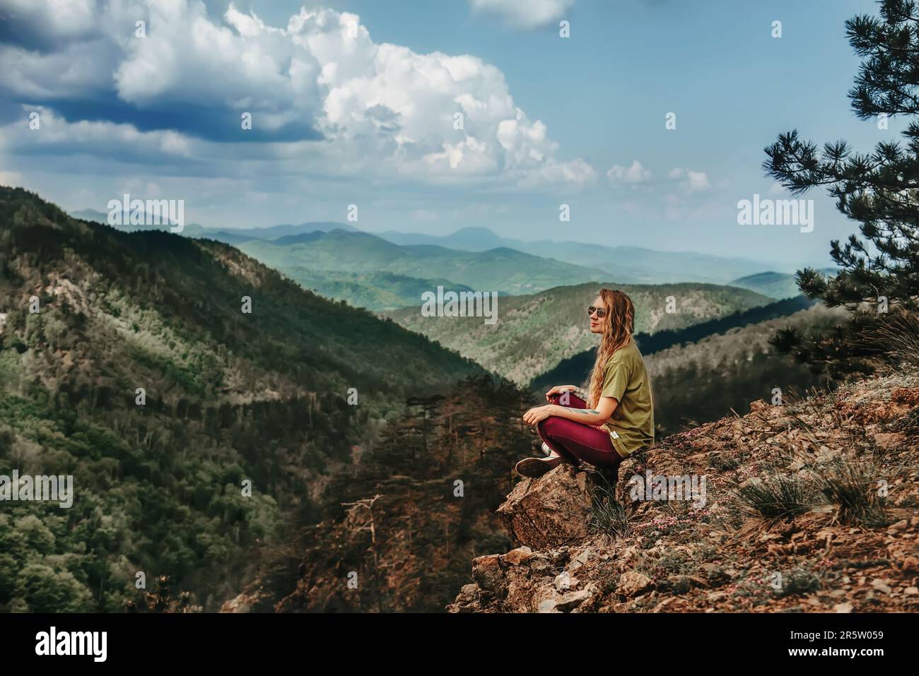 Girl sitting on edge cliff hi-res stock photography and images - Alamy