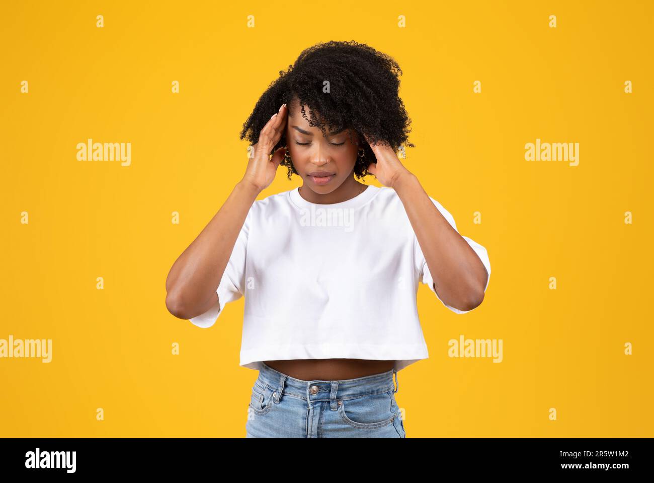 Woman presses hands temples in hi-res stock photography and images - Alamy