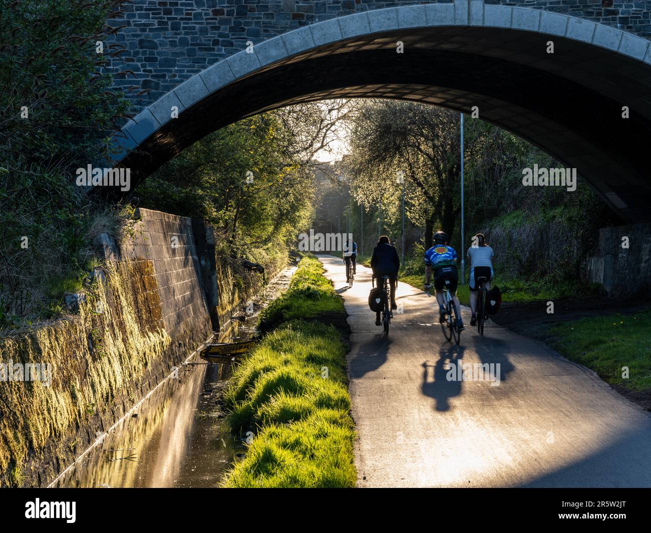 Cyclists approach the Staple Hill Tunnel on the Bristol and Bath Railway Path Stock Photo