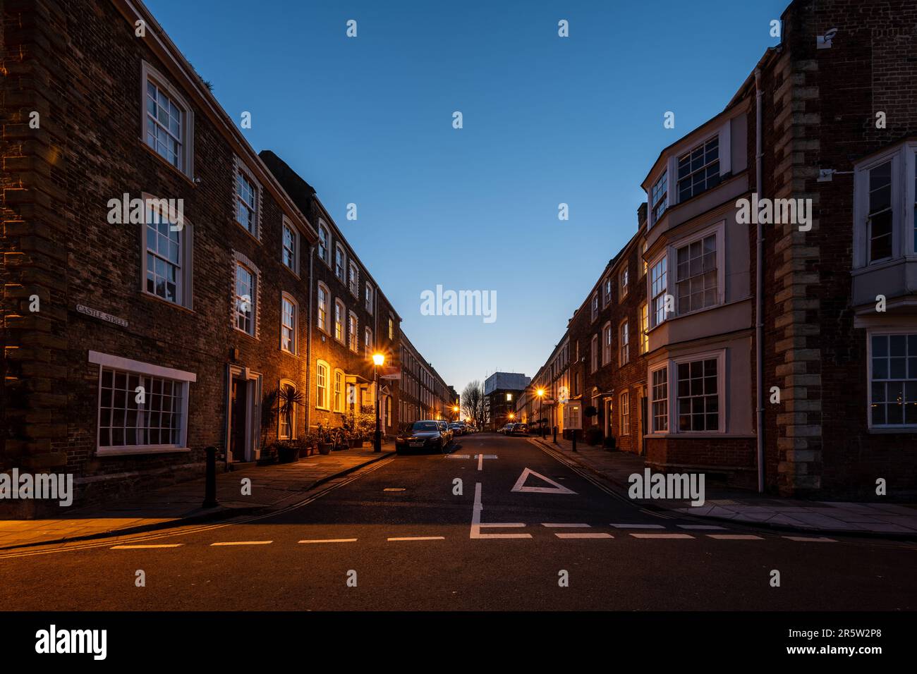 Georgian town houses are lit at dusk on Castle Street in Bridgwater, Somerset. Stock Photo