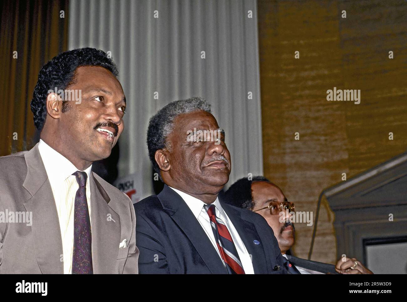 CHICAGO, ILLINOIS - FEBRUARY 24, 1987 Reverend Jesse Jackson sits next to incumbent Chicago Mayor Harold Washington at his primary election victory celebration over Jane Byrne thus winning the Democratic nomination for mayor which he easily won reelection in the general election the following November. On November 25 Washington suffered a fatal heart attack in his office and died at age 65. Stock Photo