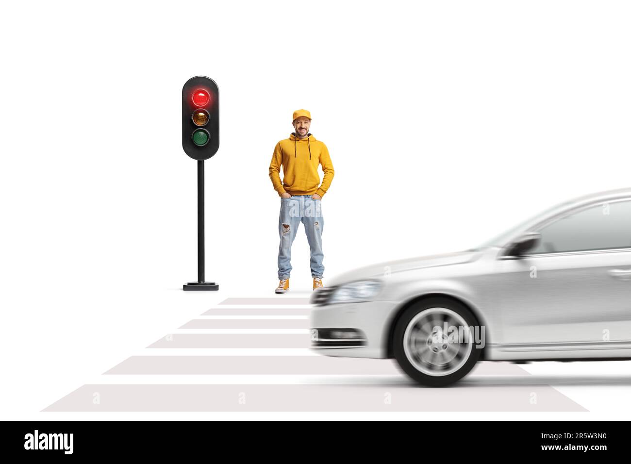 Full length portrait of a young man waiting for a green light at pedestrian crosswalk isolated on white background Stock Photo