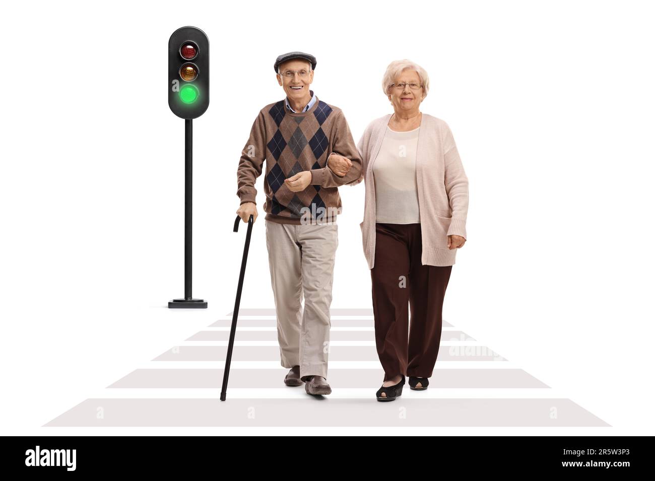 Full length portrait of an elderly man and woman walking at pedestrian crosswalk isolated on white background Stock Photo