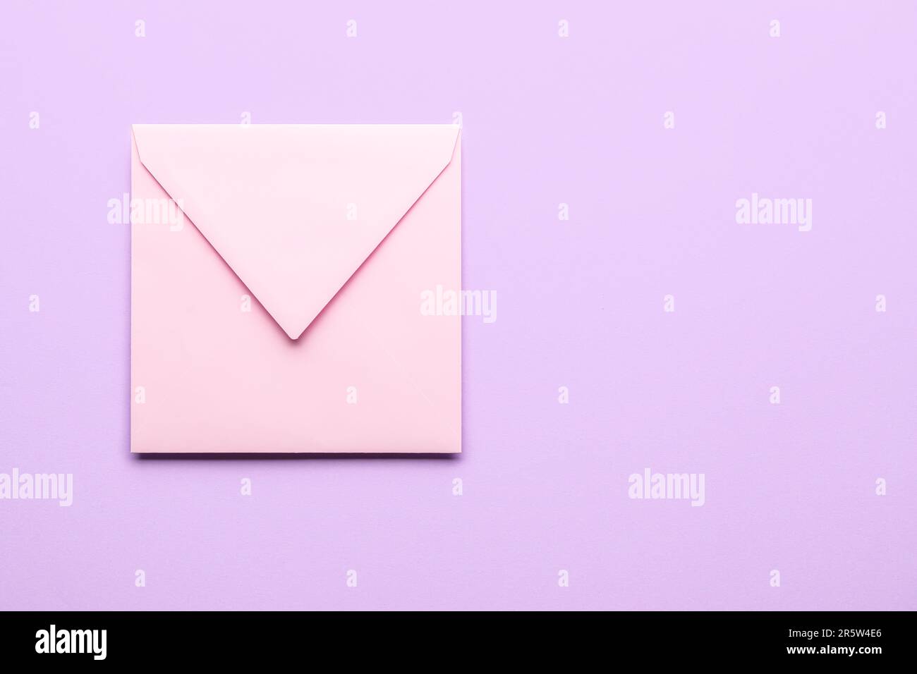 Pink envelope on lilac background. Message concept Stock Photo - Alamy
