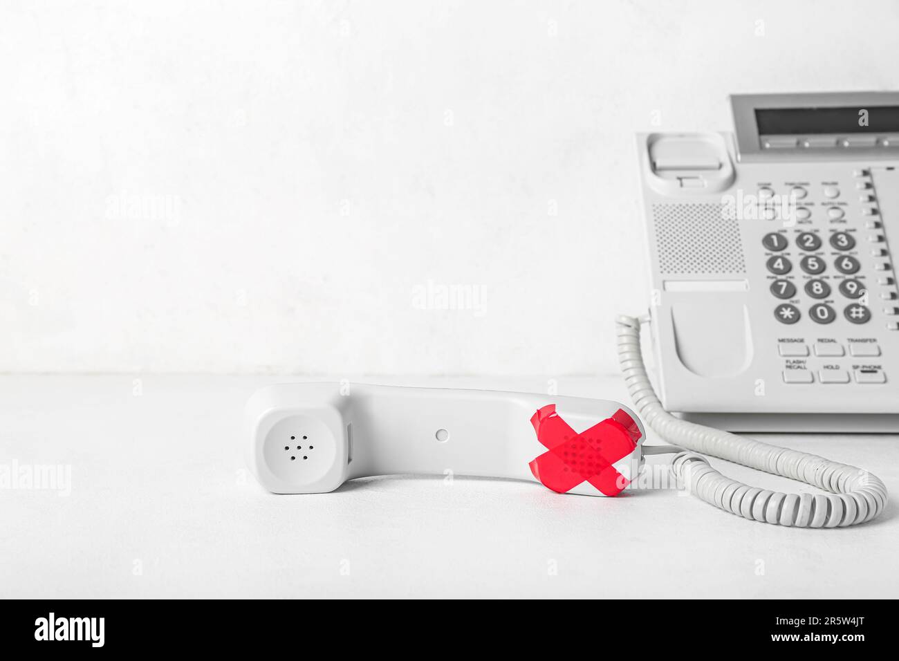 Taped phone receiver on white background. Censorship concept Stock Photo