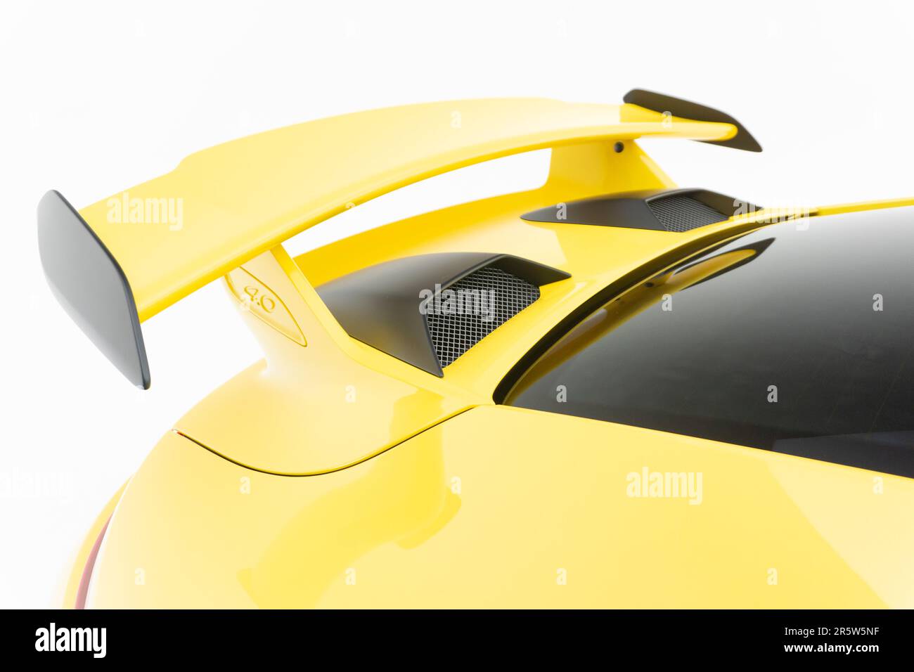 A closeup of a car's rear spoiler, showcasing its aerodynamic design and sleek black finish Stock Photo