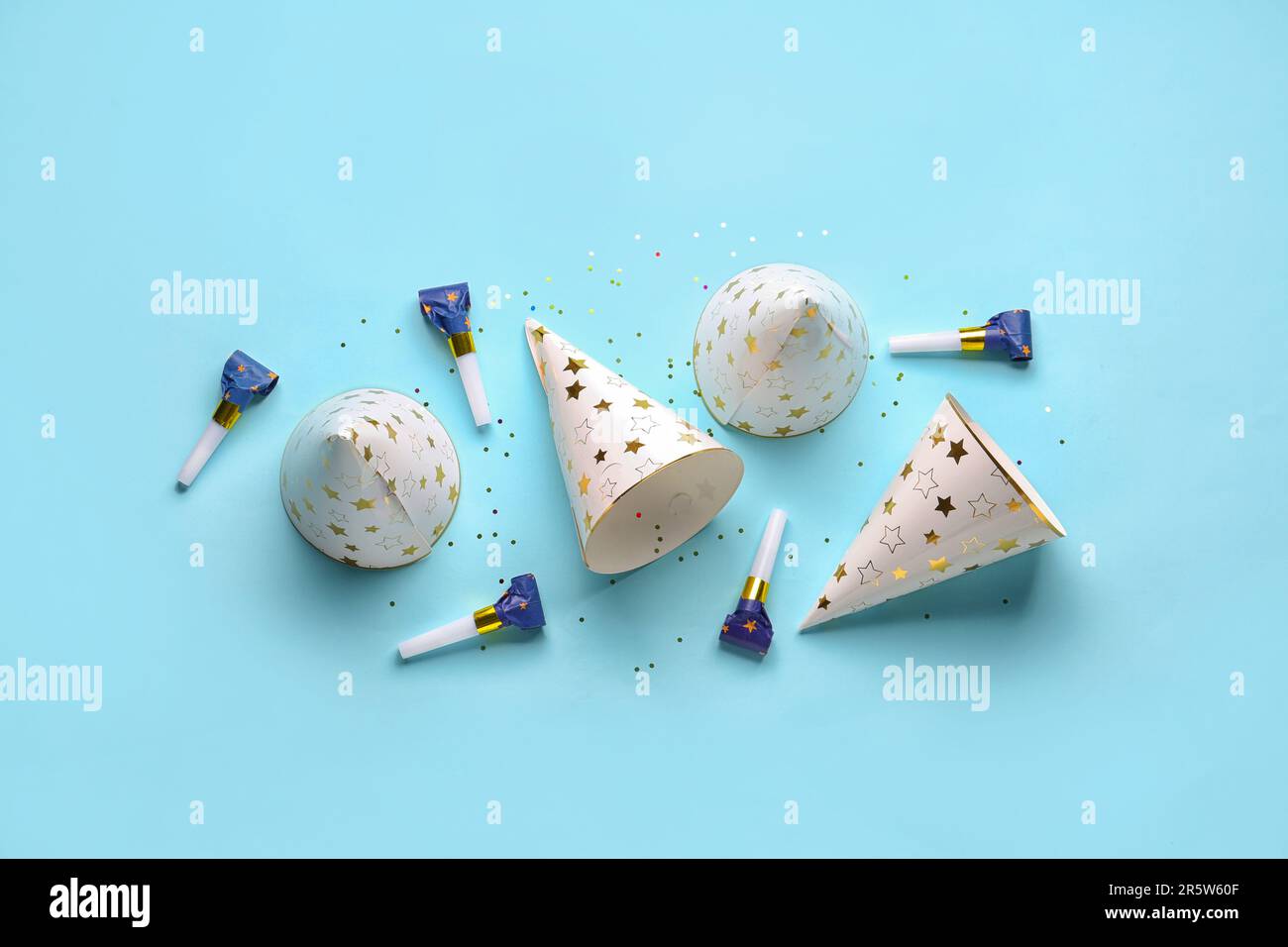 Composition with party hats and whistles on pale blue background Stock ...