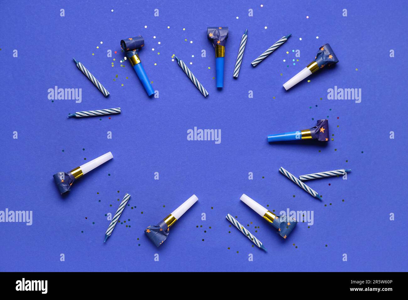 Frame made of whistles and candles for birthday party on dark blue ...