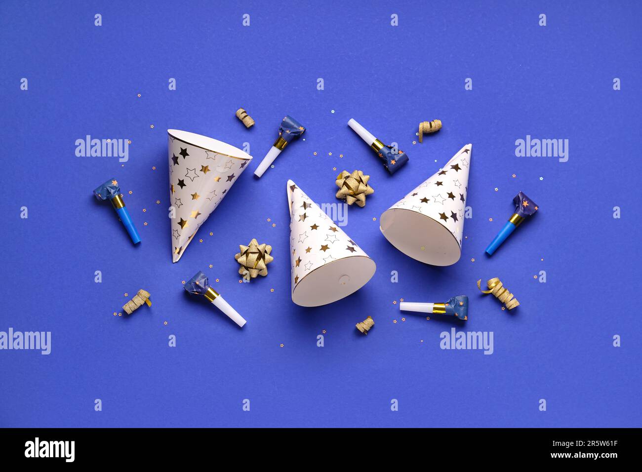 Party hats and whistles on dark blue background Stock Photo - Alamy