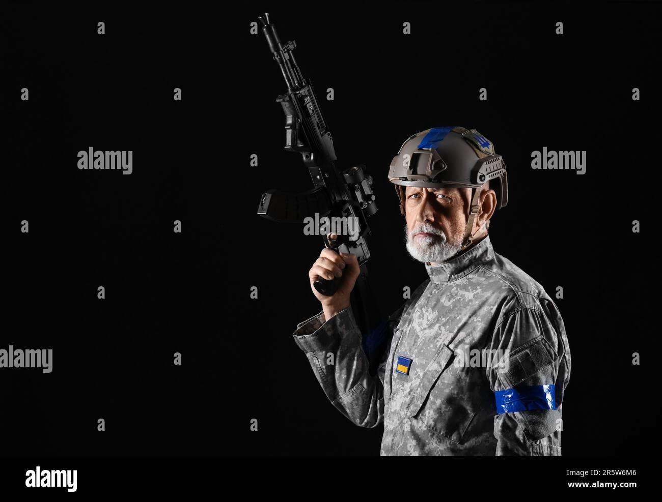 Ukrainian soldier with assault rifle on dark background Stock Photo - Alamy