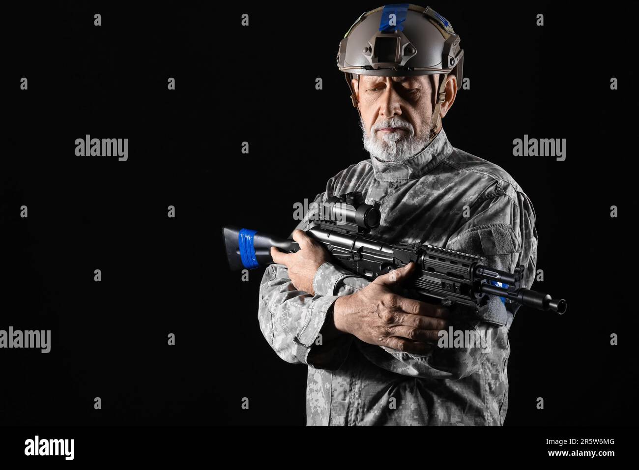Ukrainian soldier with assault rifle on dark background Stock Photo - Alamy