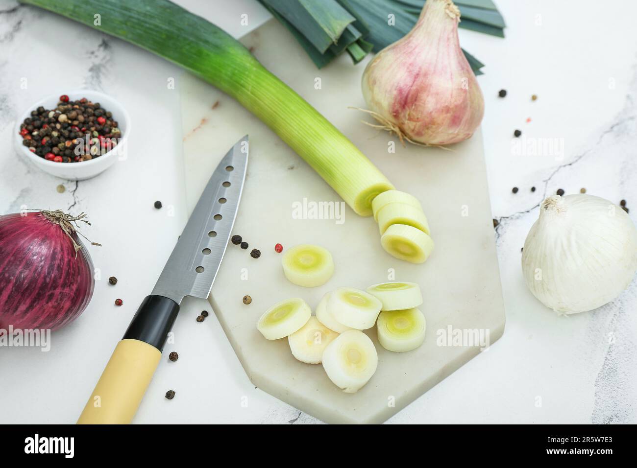 Board with different kinds of onion on grunge white background Stock ...