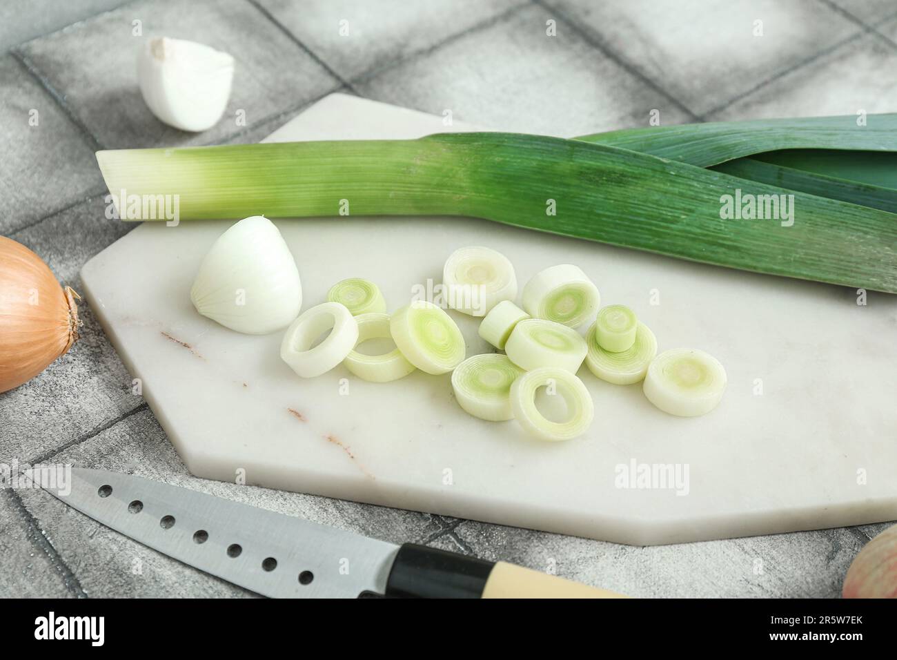 Board with different kinds of onion on grunge grey background Stock ...