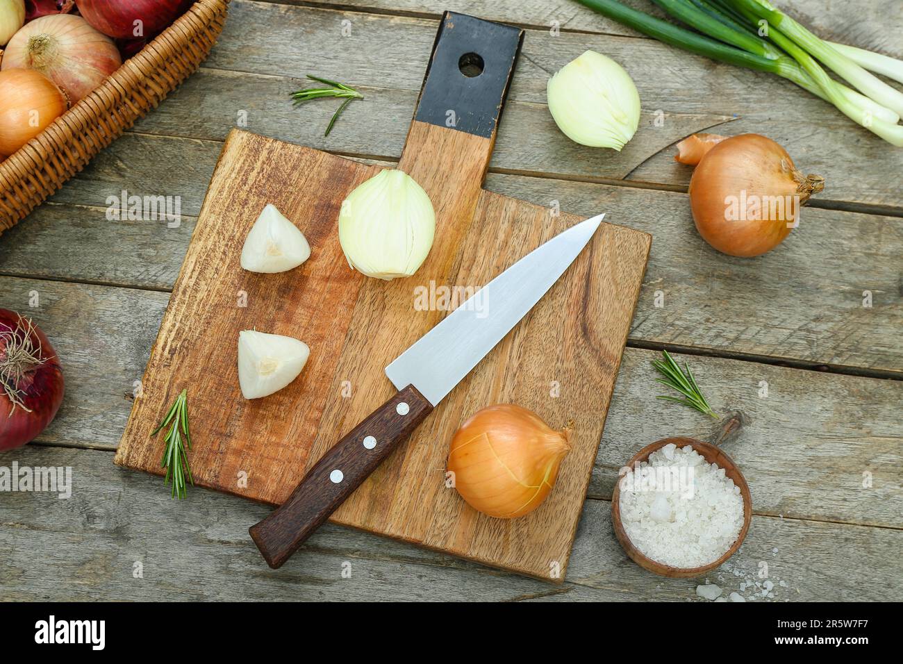 Board with different kinds of onion on brown wooden background Stock ...