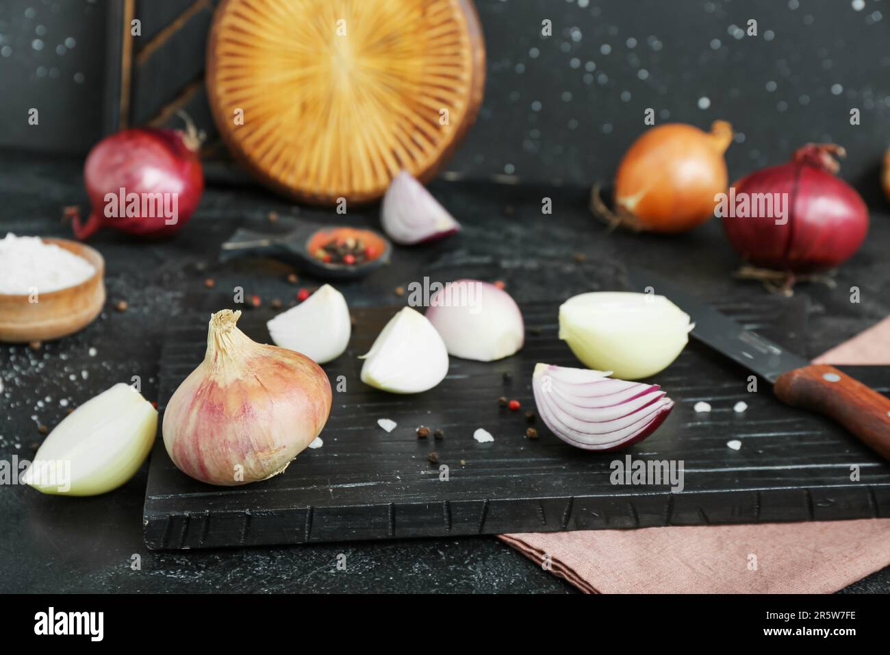 Boards with different kinds of onion on grunge black background Stock ...