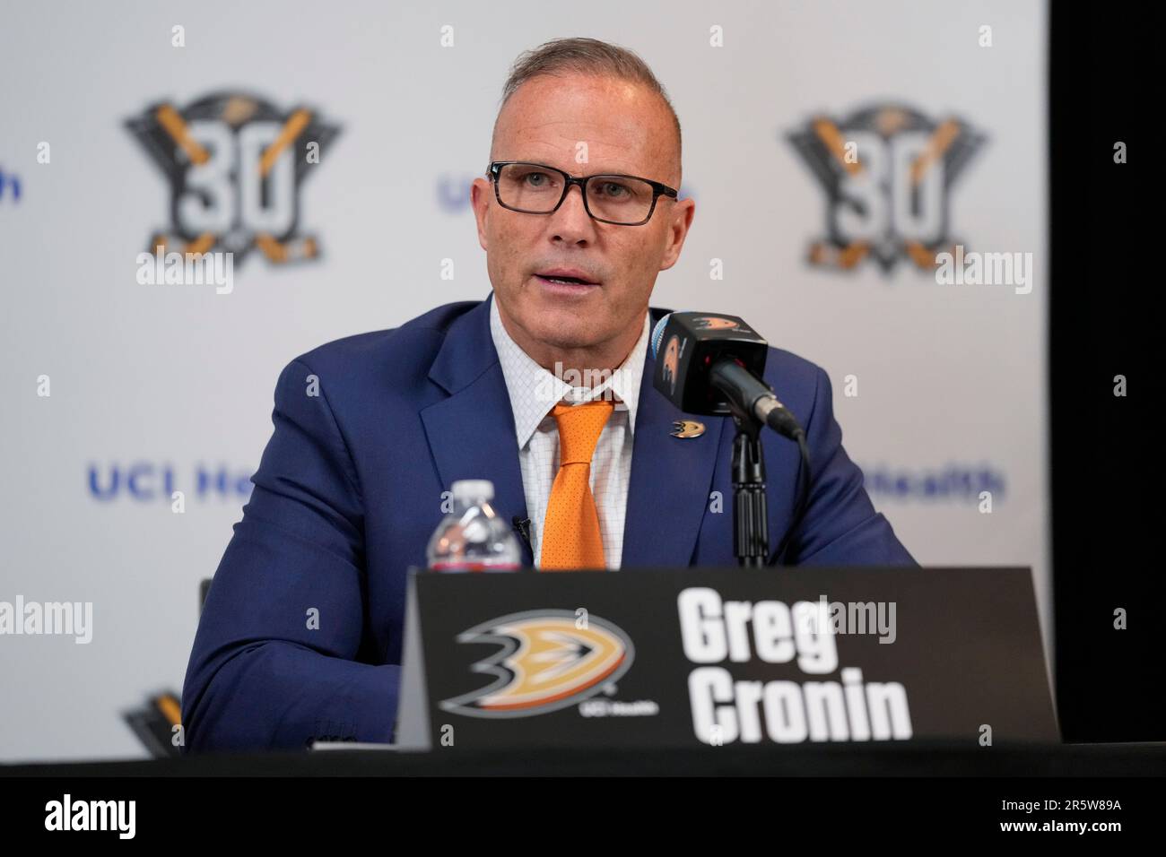 Greg Cronin speaks to reporters during a press conference announcing