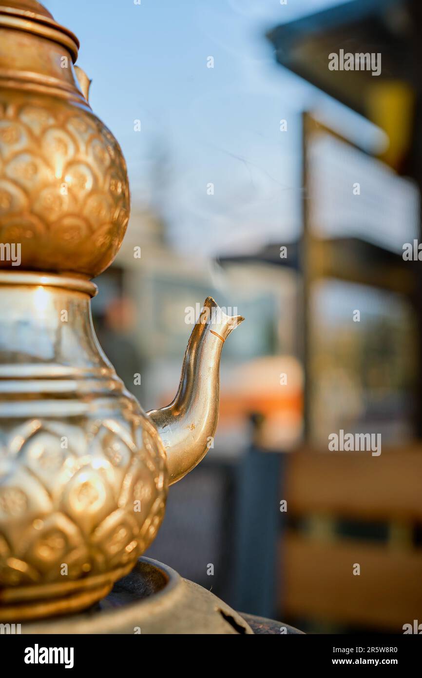 Selective focus on a Turkish teapot with rising steam from boiling