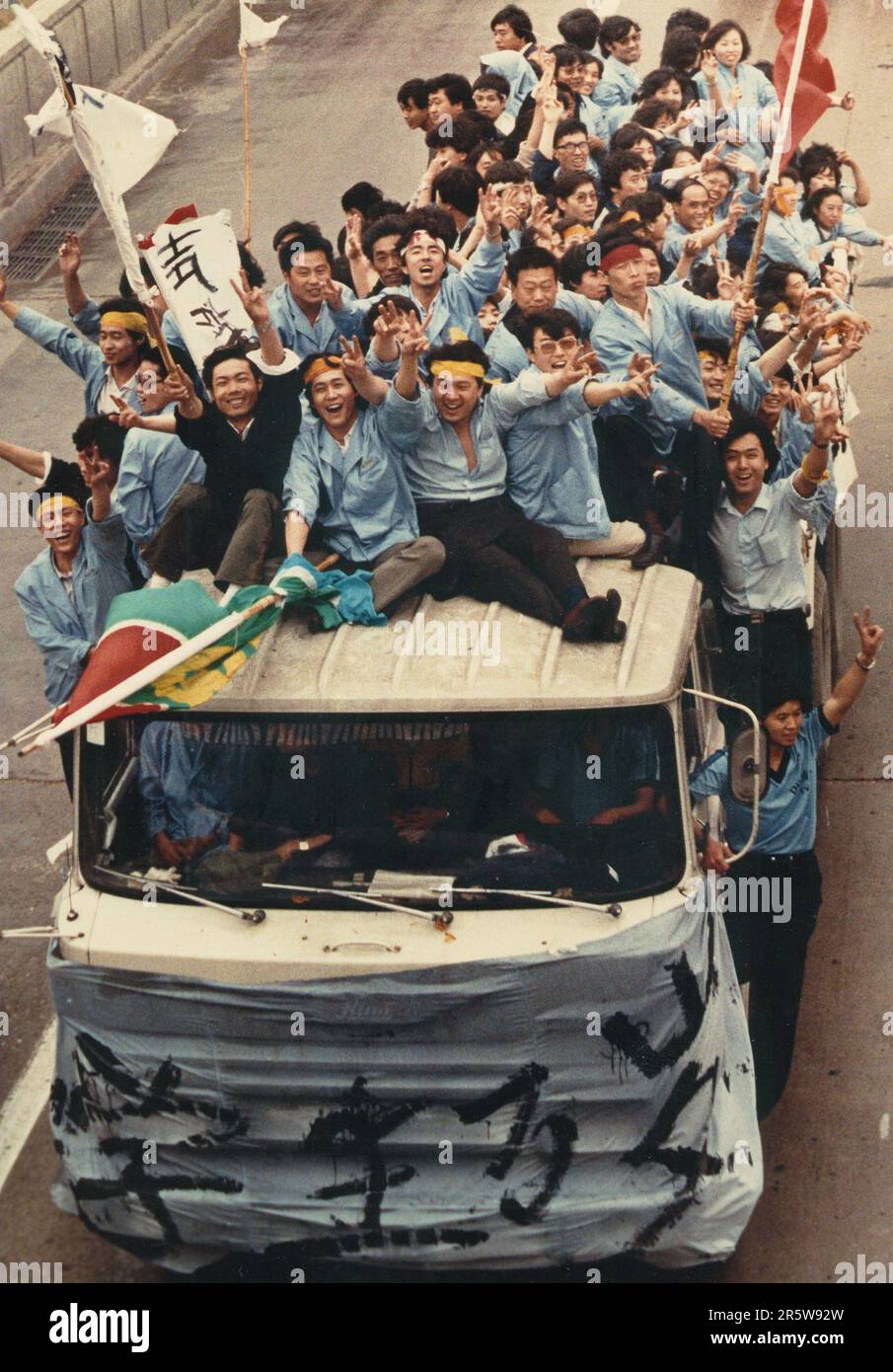 Chinese workers supporting pro-democracy student protesters on Tiananmen Square ride through the streets of Beijing on May 18, 1989. Stock Photo