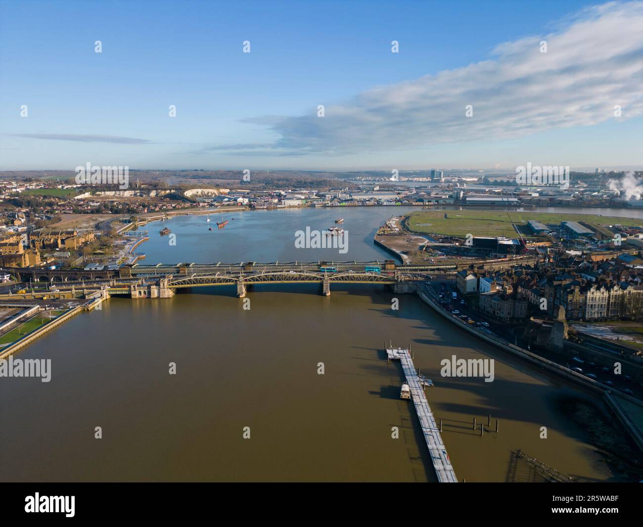 An aerial view of a river with boats and a bridge in Rochester, UK ...
