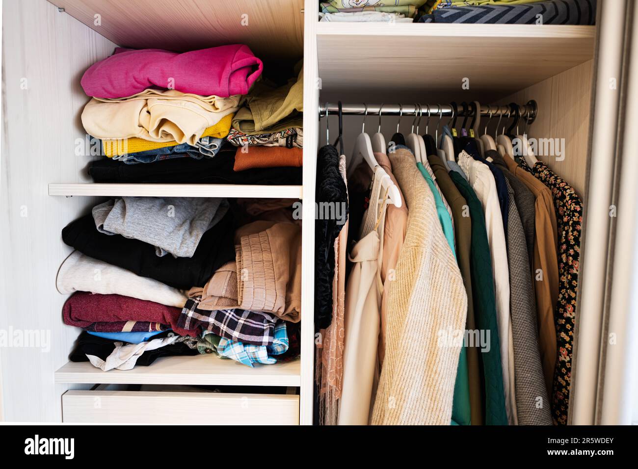 Closet with different clothes in wardrobe Stock Photo - Alamy