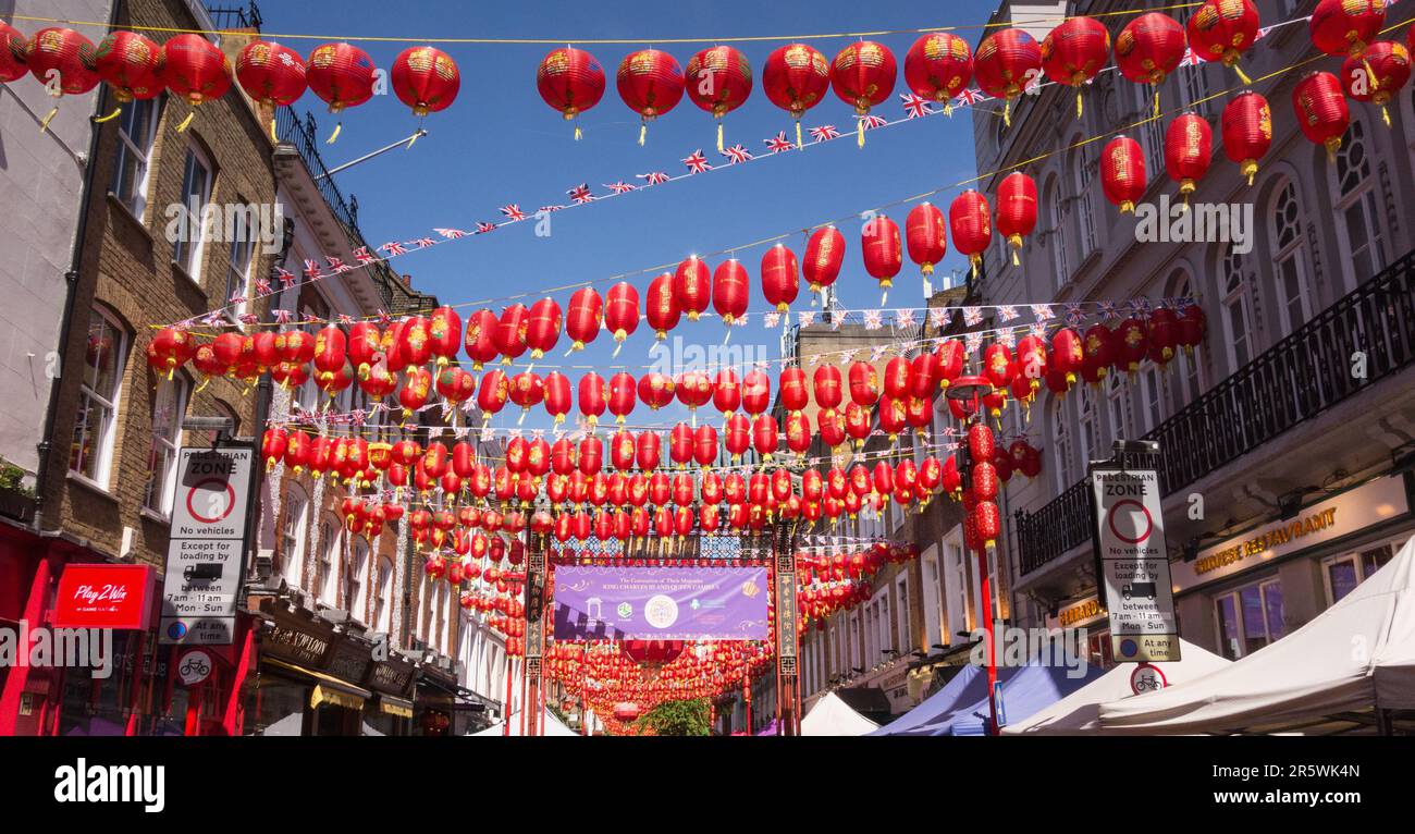 Crowds of tourists and red paper lanterns on Gerrard Street in Chinatown, Soho, central London, England, U.K. Stock Photo