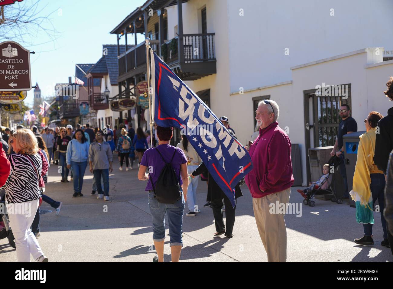 St. Augustine, Florida - December 28, 2022: Woman carries a Trump Won maga flag along historic St. Charles street in St. Augustine FL Stock Photo