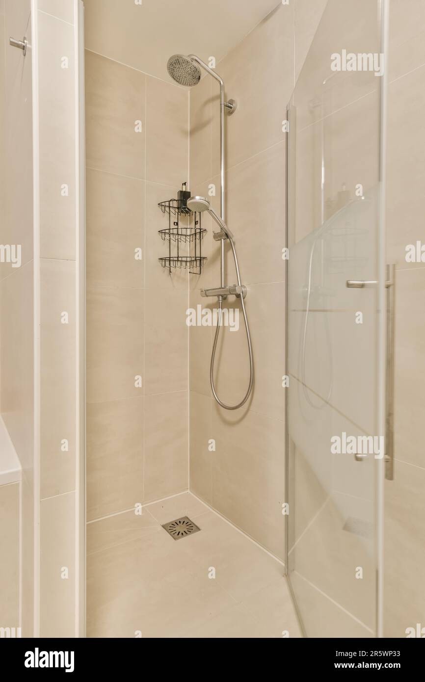 a bathroom with a shower stall and stand up shower head rester in the