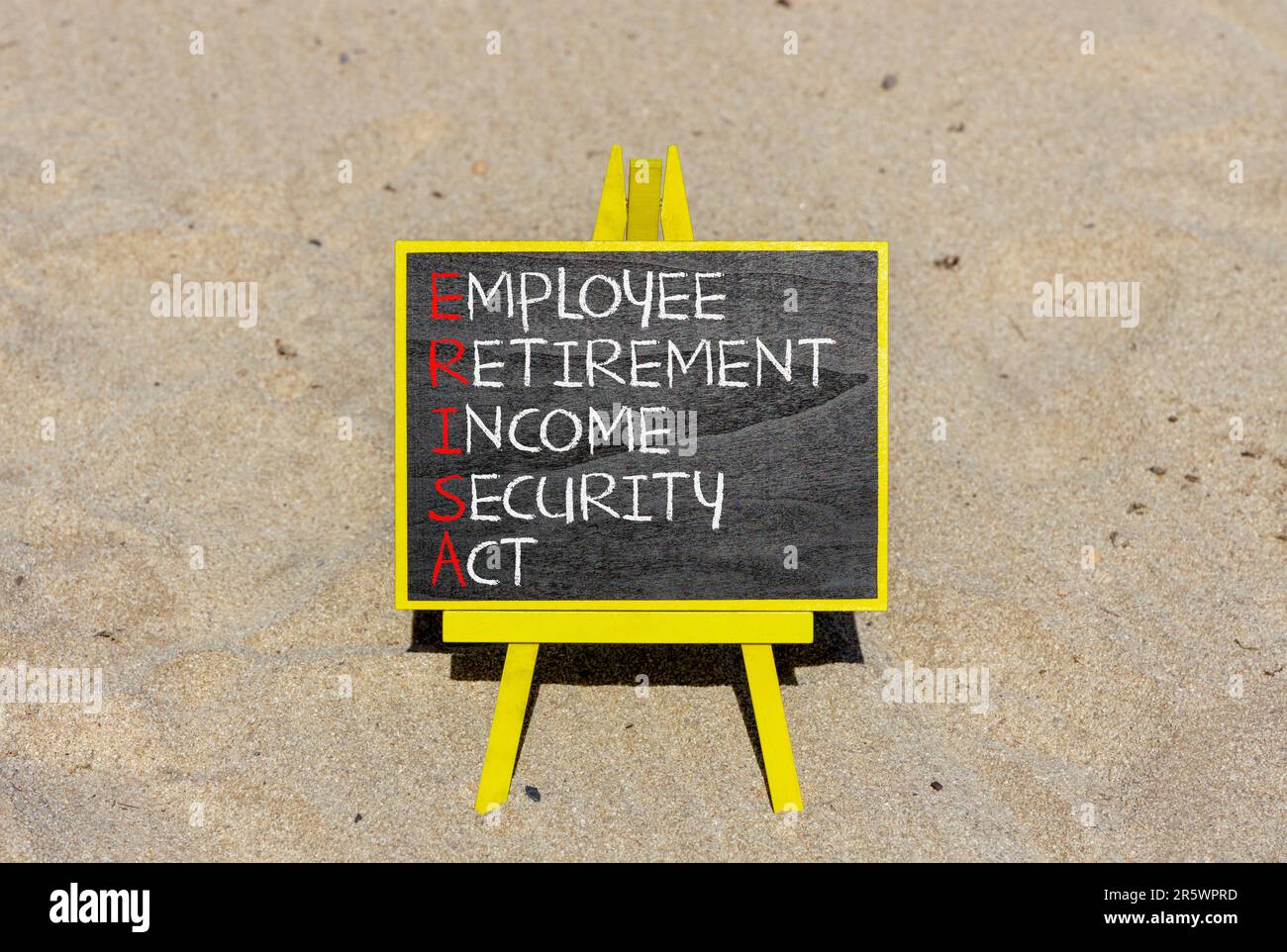 ERISA symbol. Concept words ERISA employee retirement income security act on beautiful black blackboard. Beautiful sand background. Business ERISA emp Stock Photo