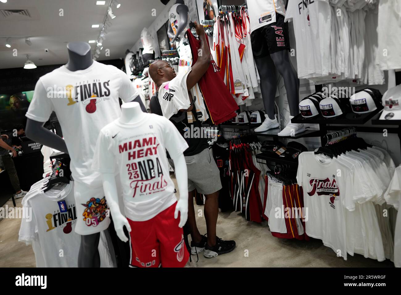 Garner Buckley, 36, a New York transplant who has embraced the Miami Heat  basketball team since moving down in 2021, shops for Heat gear to wear to  NBA Finals watch parties, Monday