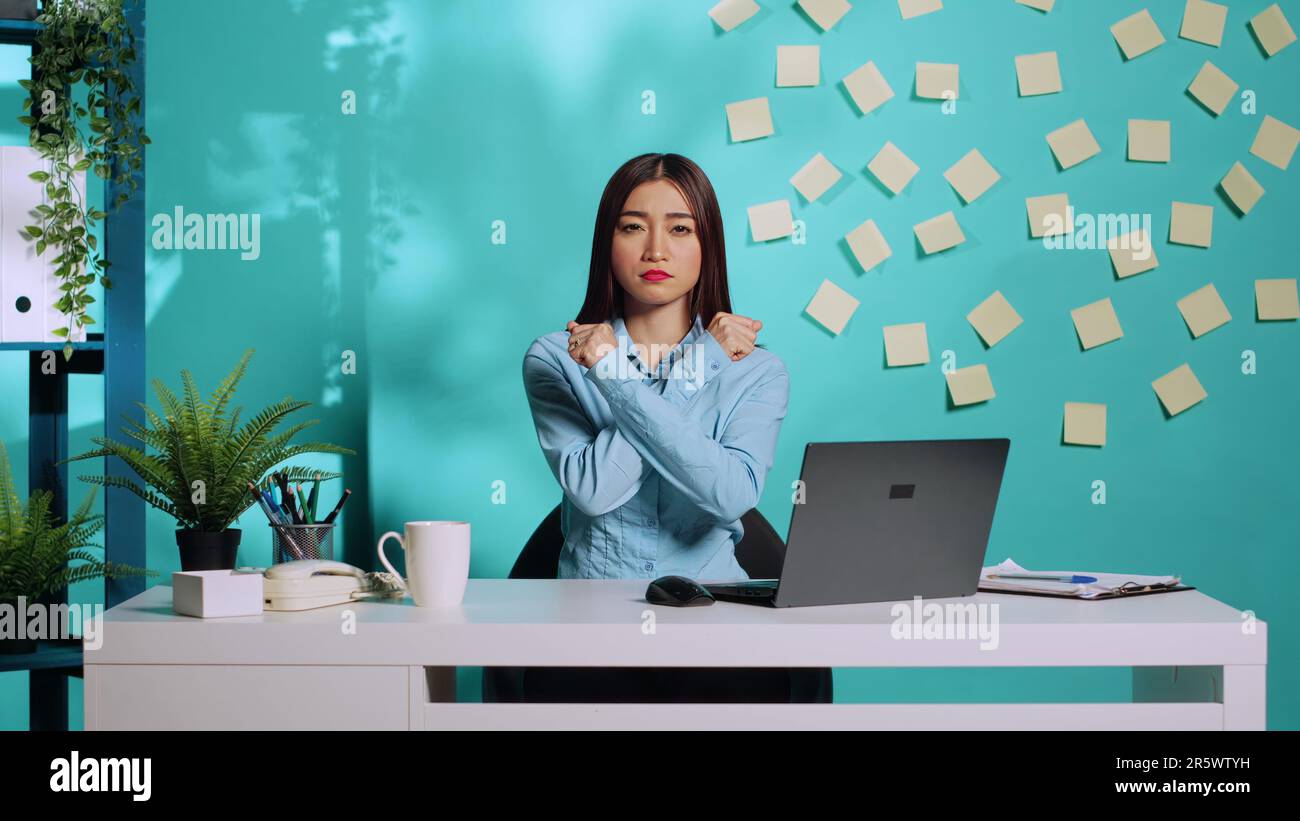 Assertive asian employee adamant about saying no, confident in her