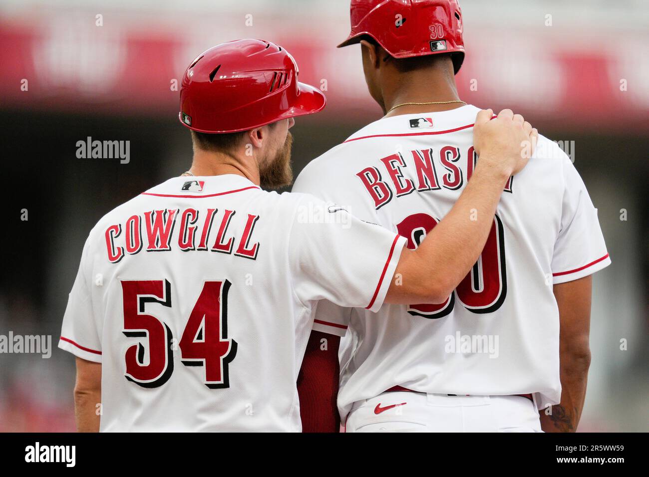 Cincinnati Reds first base coach Collin Cowgill (54) embraces Will