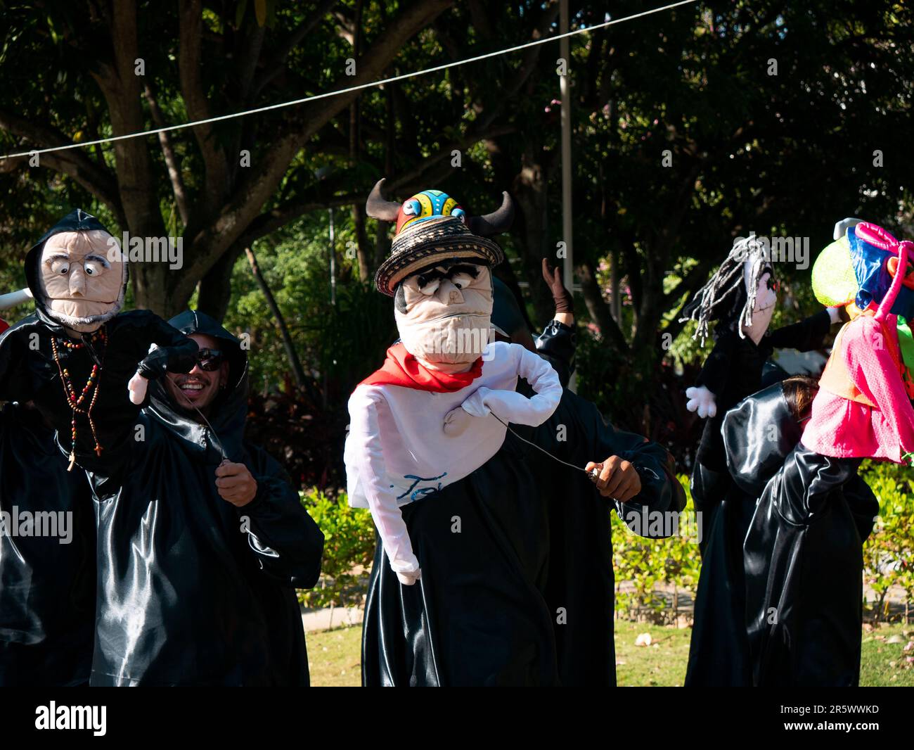Barranquilla, Colombia - February 21 2023: Colombian Men y Women Wear Black Costumes Parade Dancing with Puppets at the Famous Carnival of Barranquill Stock Photo