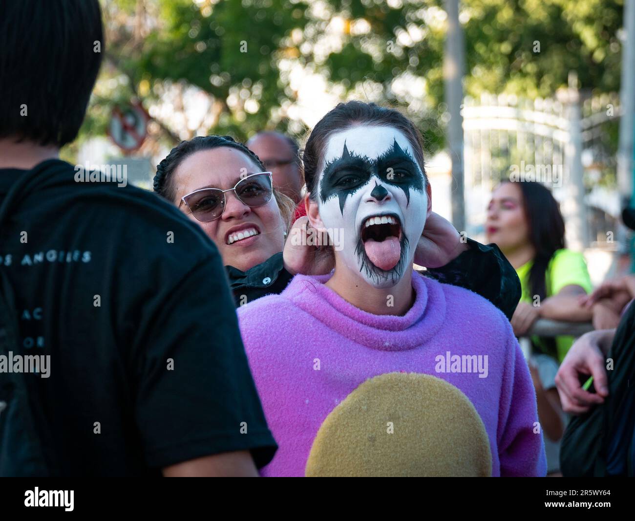 Barranquilla, Atlantico, Colombia - February 21 2023: Young Colombian Woman with White Face Paint and Black Eyes is Wearing a Purple Costume at Carniv Stock Photo