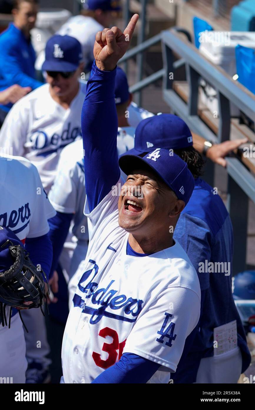 Los Angeles Dodgers manager Dave Roberts (30) greets a fan before a