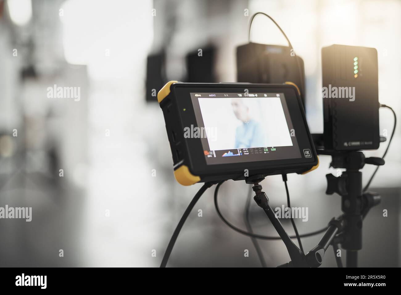 What we see behind the camera. Behind the scenes shot of videography recording equipment and a