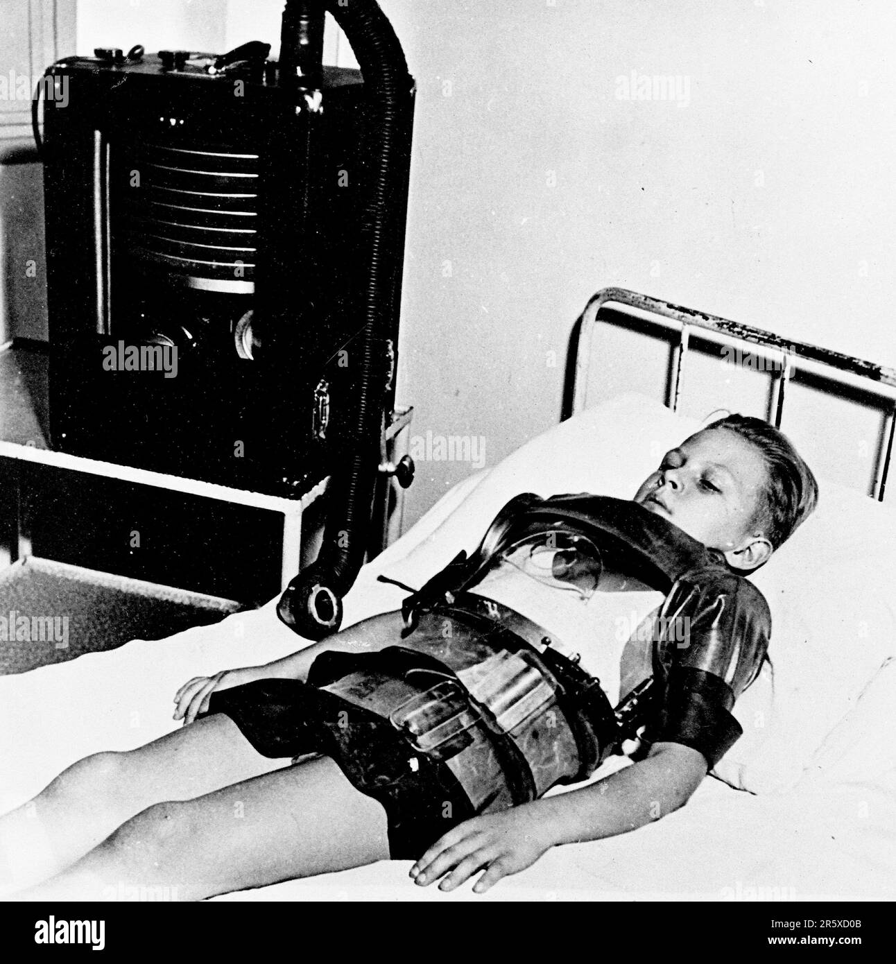 A young boy breathing with the help of a breathing apparatus bought with Marshall Plan funds. The Marshall Plan was a very ambitious financial aid program proposed by US Secretary of State George Marshall. He understood that a destroyed and prostrate Europe had to have financial help if it were to recover and to remove the threat of communist insurgency. The aid was given not lent and each country decided on how it would use the funds. In the three years of the program the US gave Europe $13 billion, a colossal sum worth $175 billion at todays values. This far-seeing and generous plan was a ma Stock Photo