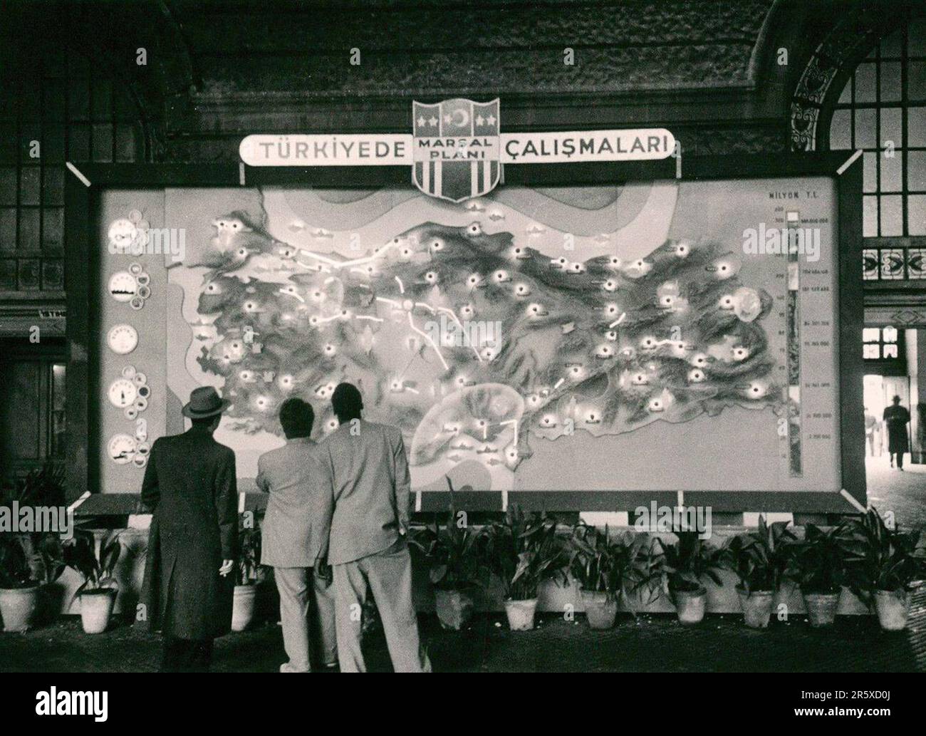 Men looking at a map of Turkey with sites being repaired with Marshall Plan funds marked. The Marshall Plan was a very ambitious financial aid program proposed by US Secretary of State George Marshall. He understood that a destroyed and prostrate Europe had to have financial help if it were to recover and to remove the threat of communist insurgency. The aid was given not lent and each country decided on how it would use the funds. In the three years of the program the US gave Europe $13 billion, a colossal sum worth $175 billion at todays values. This far-seeing and generous plan was a major Stock Photo
