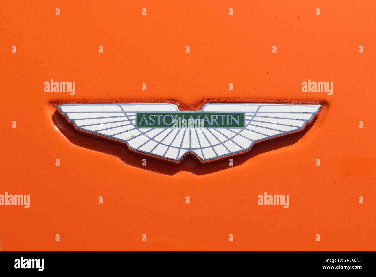 Aston Martin iconic bonnet badge on a DB9 sports car painted in the classic Gulf Oils blue and orange racing livery, May 2023. Stock Photo