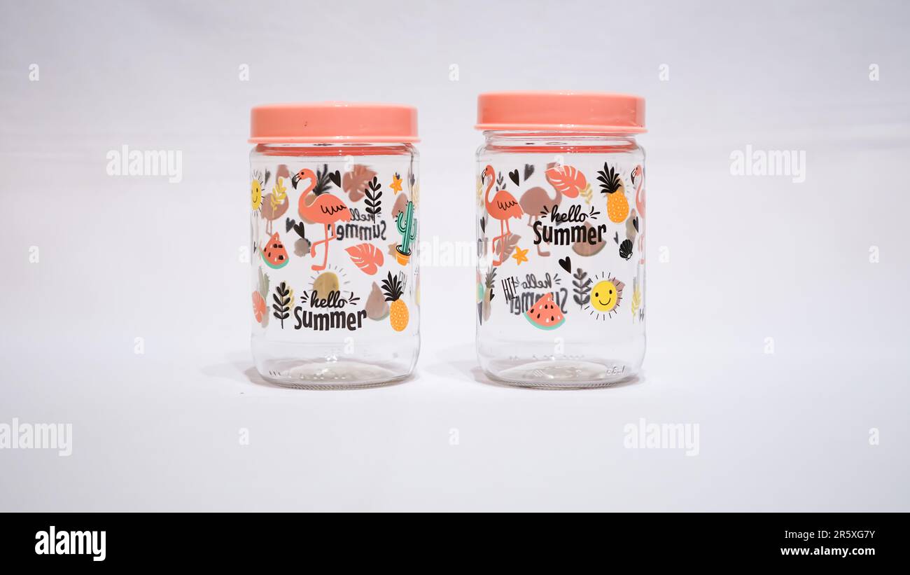 Add a touch of whimsy to your home decor with these glass jars featuring playful motifs of fruits and animals. These jars are not only functional for Stock Photo