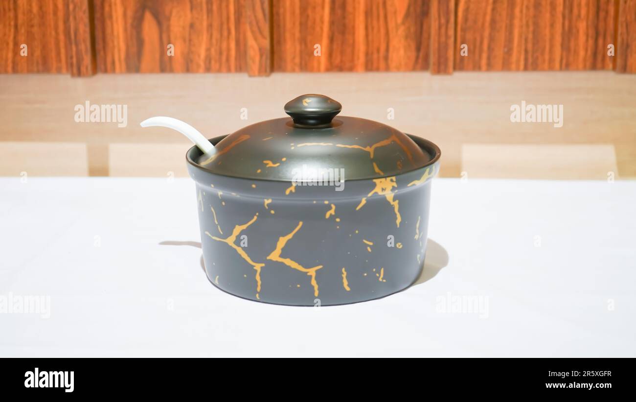 This set includes round ceramic bowls in a sleek black color adorned ...