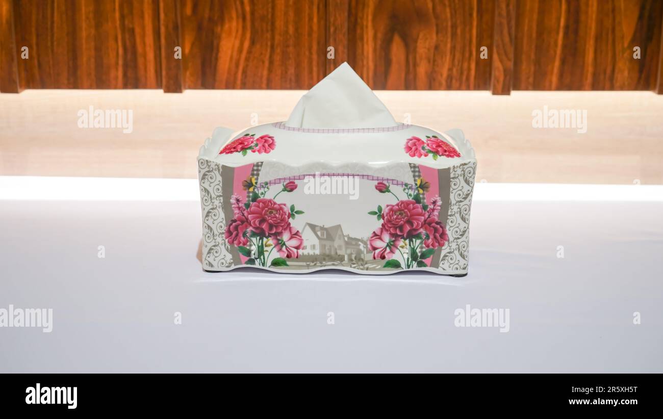 This Pink Flower Pattern Ceramic Tissue Box is the perfect addition to any room decor. Stock Photo