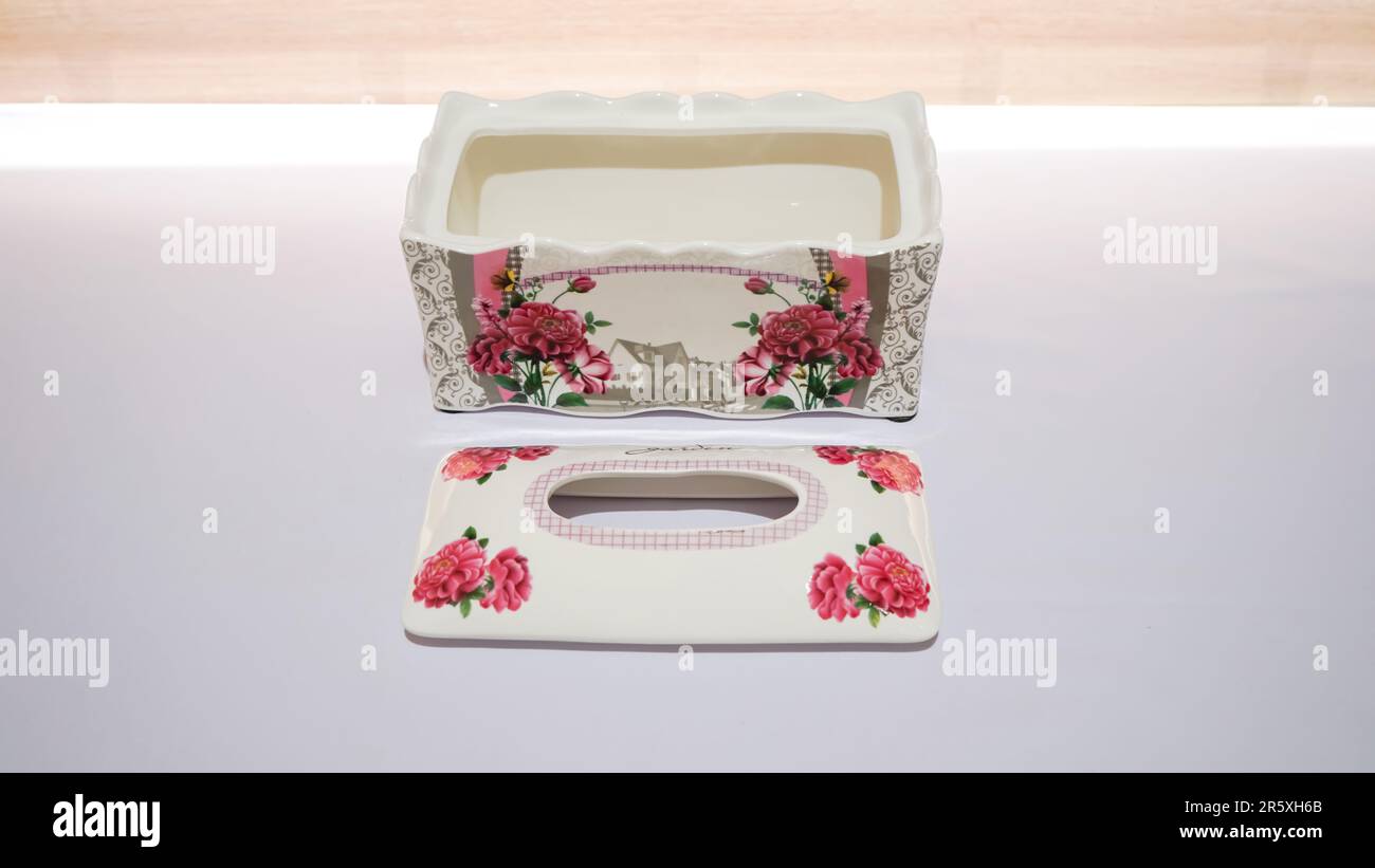 This Pink Flower Pattern Ceramic Tissue Box is the perfect addition to any room decor. Stock Photo