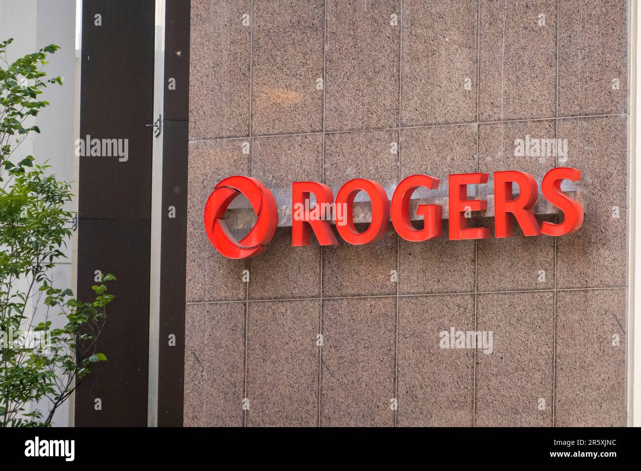 Calgary, Alberta, Canada. Jun 4, 2023. A Rogers entrance sign. A Canadian communications and media company operating in the fields of wireless communi Stock Photo